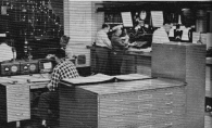 This photo from 1960 shows Fire Main at city hall, the dispatch center where telephone calls, such as the call reporting the OLA fire, were received. Here, operators would answer the phones, and depending upon the type of call, dispatch an ambulance, fire companies, or whatever was appropriate. Box alarms were received and dispatched here as well. The information was sent, via a “joker” and P.A. speakers in the various fire houses, by the dispatcher in front of the microphone in the center of the picture. Part of an electric wall map of the city's fire and rescue companies is visible at the upper left. (Photo courtesy of Greg Boyle)